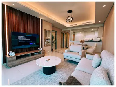 a living room with a couch and a tv at Spectacular views on high floor with Infinity Pool in Dubai