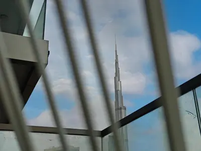 a view of the burj khalifa seen through a window at Spectacular views on high floor with Infinity Pool in Dubai
