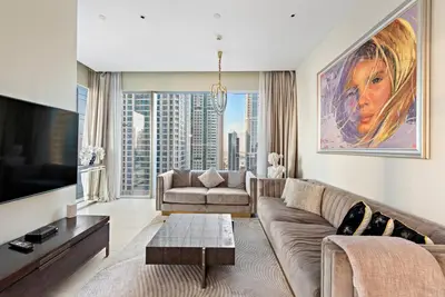 a living room with a couch and a tv at Luxury 2BR with Marina Views Near Dining Shopping Attractions & Beaches in Dubai