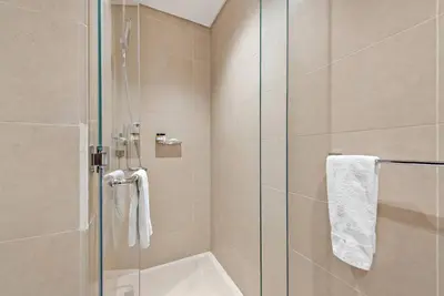 a bathroom with a shower with a glass door at Luxury 2BR with Marina Views Near Dining Shopping Attractions & Beaches in Dubai
