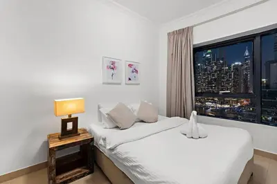 a hotel room with a bed and a window at Dubai Marina 3BR Apartment, Steps to Marina Walk, Marina Beach & JBR in Dubai