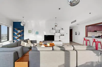 a living room with a couch and a table at Dubai Marina 3BR Apartment, Steps to Marina Walk, Marina Beach & JBR in Dubai