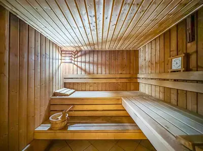 a wooden sauna with a bucket in the middle at Dubai Marina 3BR Apartment, Steps to Marina Walk, Marina Beach & JBR in Dubai