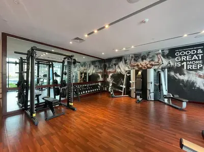a gym with cardio equipment and a wall with a mural at Modern Studio Downtown DT1, Walk to Dubai Mall, Burj View & Metro in Dubai
