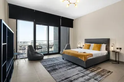a bedroom with a king sized bed and a balcony at Modern Studio Downtown DT1, Walk to Dubai Mall, Burj View & Metro in Dubai