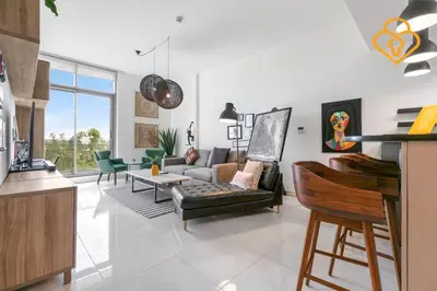 a living room with a couch and a table at Keysplease 1 BR Polo Residence, Meydan in Dubai