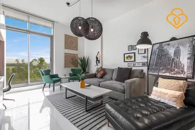 a living room with a couch and a table at Keysplease 1 BR Polo Residence, Meydan in Dubai