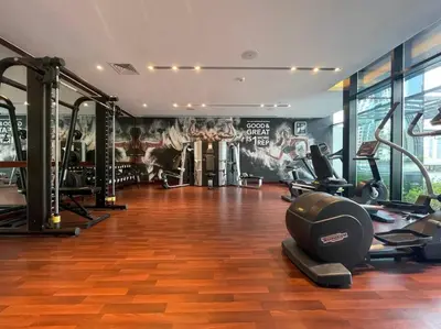 a gym with treadmills and machines in a room at FIRST CLASS Studio Stylish Urban Escape in Dubai