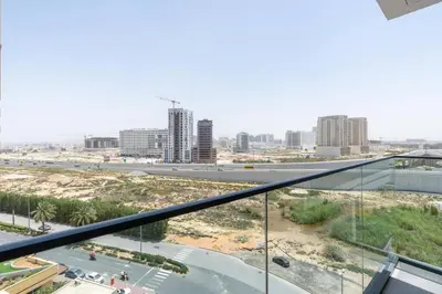 a view of a city from a balcony at Nice apartment in JVC - Dubai in Dubai