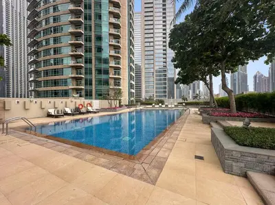 a swimming pool in a city with tall buildings at FIRST CLASS 1BR Premium & Spacious City Escape in Dubai