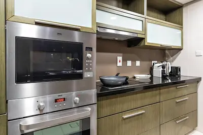 a kitchen with a stainless steel stove top oven at FIRST CLASS 1BR Premium & Spacious City Escape in Dubai