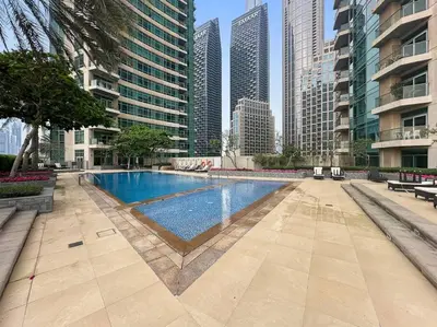 a swimming pool in a city with tall buildings at FIRST CLASS 1BR Premium & Spacious City Escape in Dubai