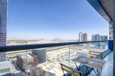 a balcony with a table and a view of a city at FIRST CLASS 2BR Modern Downtown Retreat in Dubai