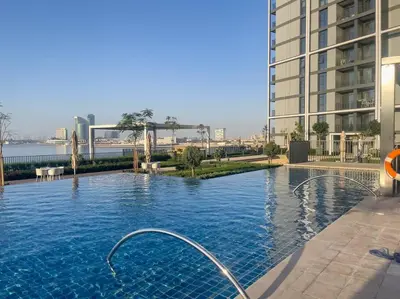 a large swimming pool in the middle of a building at Luxury Living with Panoramic View in Creek Harbour in Dubai