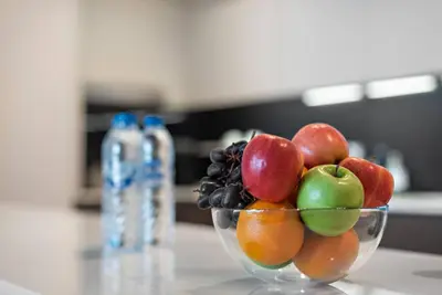 a bowl of fruit sitting on a table at FIRST CLASS 1BR Stunning Burj Khalifa Views in Dubai