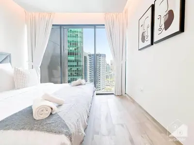 a bedroom with a bed and a large window at Luxurious 1Bedroom Balcony & View Business bay in Dubai