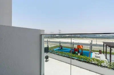 a view of a swimming pool from the balcony of a house at 1 bedroom - 12 min from downtown - Azizi Riviera in Dubai