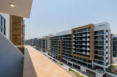 a view of an apartment building from a balcony at Studio - 12 min downtown - Pool - Azizi Riviera in Dubai