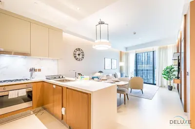 a kitchen and dining room with a dining table at Elegant 2BR Apartment at The Address Residences Dubai Opera, Downtown Dubai by Deluxe Holiday Homes in Dubai