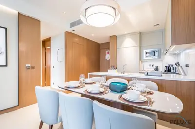 a kitchen and dining room with a table and chairs at Elegant 2BR Apartment at The Address Residences Dubai Opera, Downtown Dubai by Deluxe Holiday Homes in Dubai