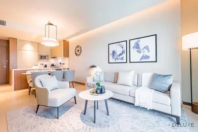 a living room with a couch and a table at Elegant 2BR Apartment at The Address Residences Dubai Opera, Downtown Dubai by Deluxe Holiday Homes in Dubai