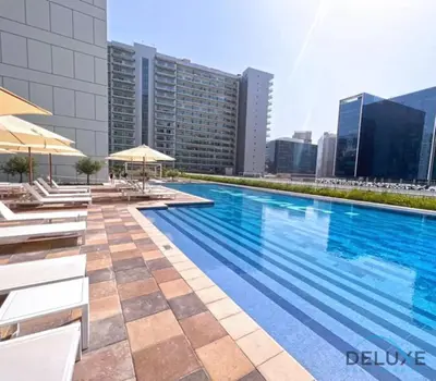 a swimming pool on the roof of a building at Calm 1BR in Vera Tower, Business Bay by Deluxe Holiday Homes in Dubai