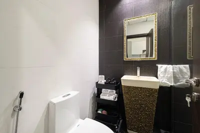 a bathroom with a toilet and a sink and a mirror at Nice studio in Arjan - Dubai in Dubai