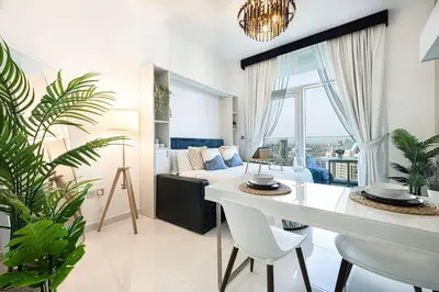a living room with a white table and a couch at Nice studio in Arjan - Dubai in Dubai