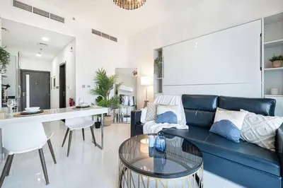 a living room with a blue couch and a table at Nice studio in Arjan - Dubai in Dubai