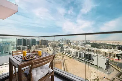 a balcony with a table and a view of a city at Studio - Miraclz Tower in Arjan in Dubai