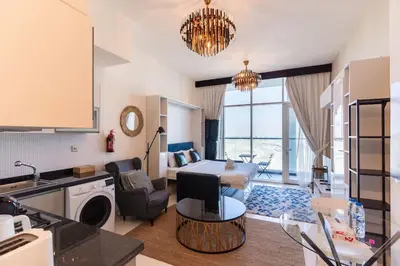 a kitchen and a living room with a table at Comfy Studio in Business Bay l Stays 2 in Dubai
