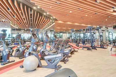 a gym with rows of treadmills and elliptical machines at Comfy Studio in Business Bay l Stays 2 in Dubai