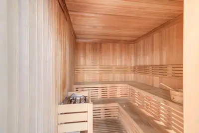a sauna with wooden walls and a wooden ceiling at Comfy Studio in Business Bay l Stays 2 in Dubai