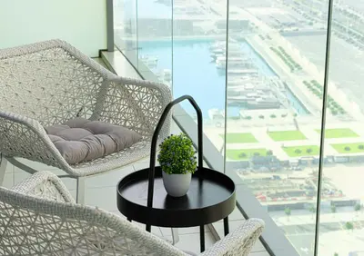a table with a potted plant on top of a balcony at Luxe Sea View High Floor 1 BR in Dubai Marina by Maxx Value Homes in Dubai