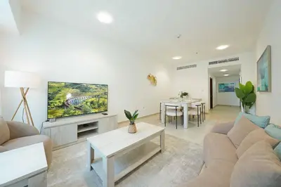 a living room with a couch and a tv at Lux 2BD apartment, Steps to the Beach in the Heart of Dubai Marina - Elite Residence Tower in Dubai
