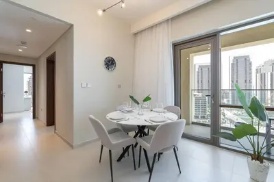 a dining room with a table and white chairs at New Listing & Vida Creek Beach & Beach Access in Dubai
