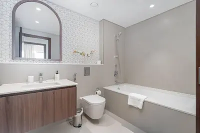 a bathroom with a sink and a toilet and a bath tub at New Listing & Vida Creek Beach & Beach Access in Dubai
