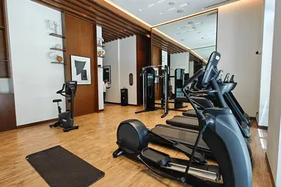 a gym with a row of treadmills and ellipticals at New Listing & Vida Creek Beach & Beach Access in Dubai