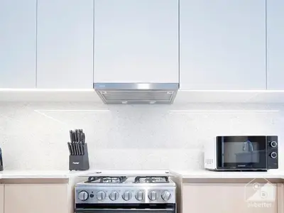 a kitchen with a stove and a microwave at Prestigious Burj Royale luxury Apartments Downtown in Dubai