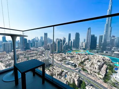 a bench in a room with a view of a city at Prestigious Burj Royale luxury Apartments Downtown in Dubai