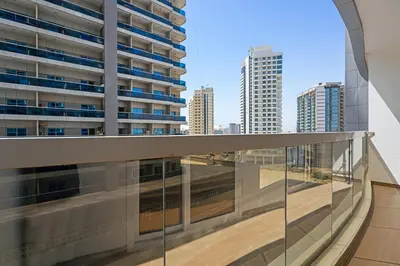 a balcony with a view of the city at Modern 1 bedroom apartment in Sports City in Dubai