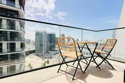 a balcony with a table and two chairs on it at Modern One Bedroom JVC in Dubai