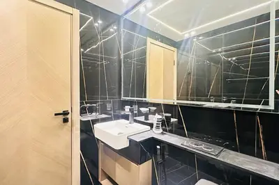 a bathroom with a sink and a mirror at Modern One Bedroom JVC in Dubai