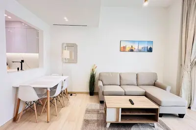 a living room with a couch and a table at Modern One Bedroom JVC in Dubai
