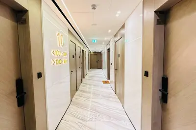 a corridor of an office building with a long hallway at Modern One Bedroom JVC in Dubai