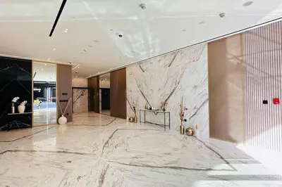 a lobby with a marble floor and a marble wall at Modern One Bedroom JVC in Dubai