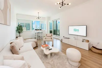 a living room with white furniture and a flat screen tv at FAM Living - Panoramic Dubai Marina View apartment in Dubai