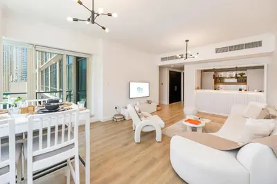 a living room with white furniture and large windows at FAM Living - Panoramic Dubai Marina View apartment in Dubai
