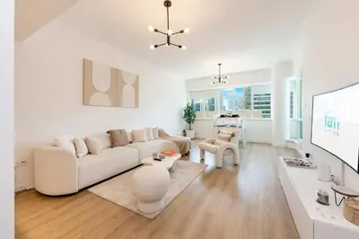a white living room with a white couch and a table at FAM Living - Panoramic Dubai Marina View apartment in Dubai