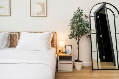 a bedroom with a white bed and a mirror at FAM Living - Panoramic Dubai Marina View apartment in Dubai